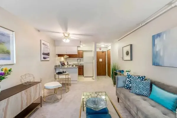 a living room with furniture and a chandelier