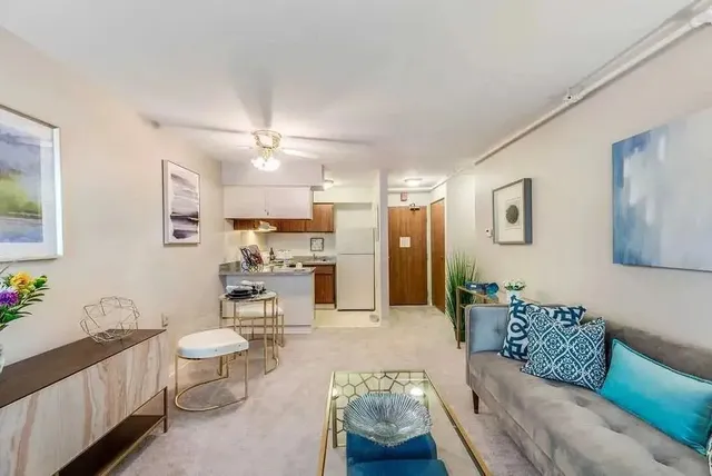 a living room with furniture and a chandelier