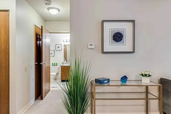 a view of a hallway with paintings on the wall