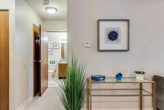 a view of a hallway with paintings on the wall