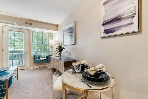 a dining room with furniture and a window