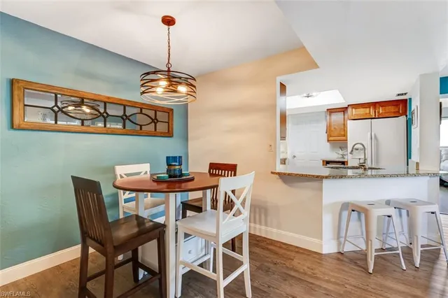 a dining room with furniture and wooden floor