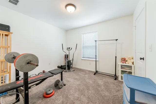 a room with gym equipment and a table