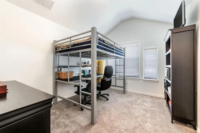 a view of a livingroom with furniture and a refrigerator