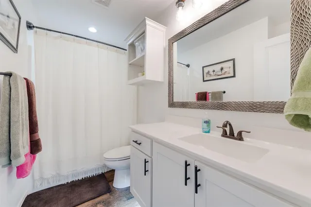 a bathroom with a sink toilet and shower