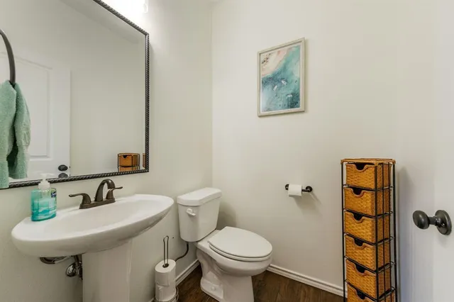 a bathroom with a sink toilet and a mirror