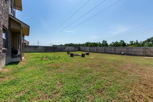 a view of a swimming pool with an outdoor seating and a yard