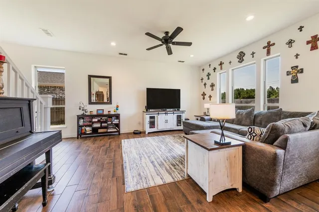 a living room with furniture and a flat screen tv