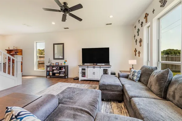 a living room with furniture and a flat screen tv