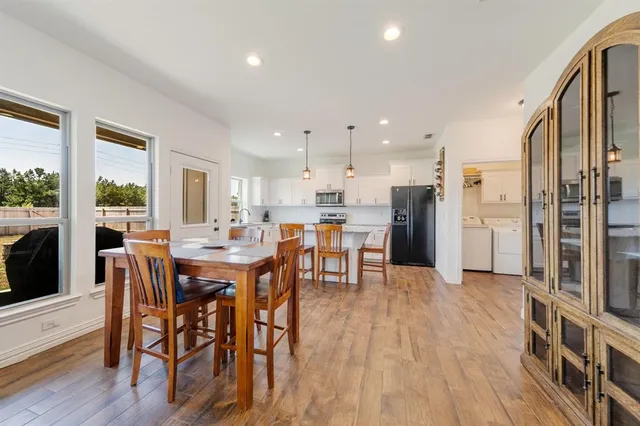 a view of a dining room with furniture and wooden floor
