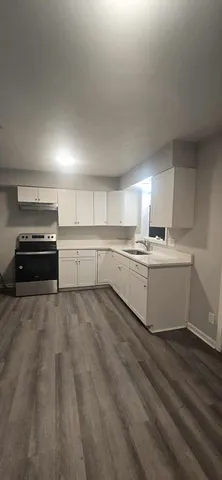 a kitchen with a white cabinets and white appliances