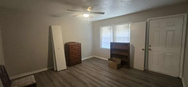 a view of a hallway with wooden floor and closet