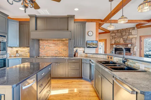a spacious bedroom with a bed and dresser with wooden floor