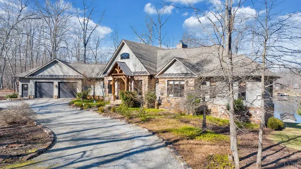 a living room with furniture and floor to ceiling windows