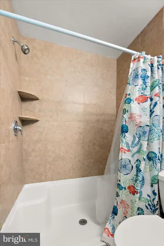 a bathroom with a bathtub and shower