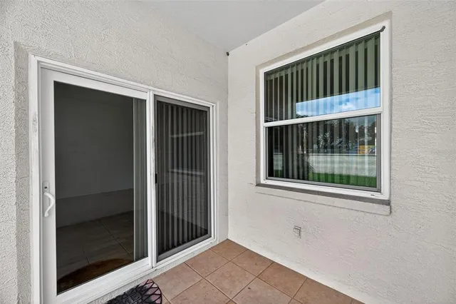 a view of a swimming pool with a table and chairs