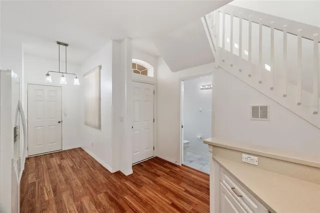 a kitchen with white cabinets appliances and sink