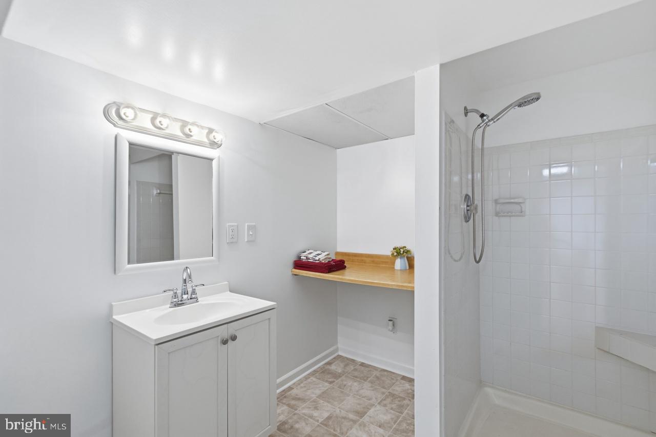 7100 Counter Place Burke, VA 22015 - Photo 46 of 54 Lower level bath, shower, storage area and shelves