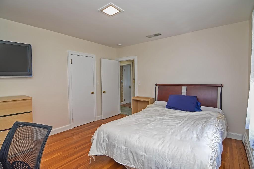 20 Westvale Road Medford, MA 02155 - Photo 24 of 42 a bedroom with a bed and a flat screen tv