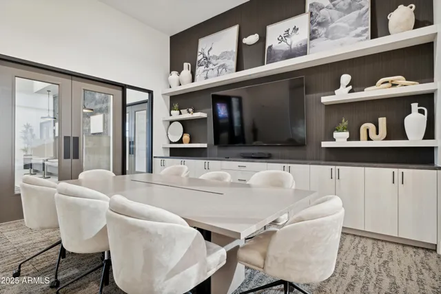 a living room with furniture and a wall painting