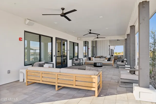 a living room with furniture ceiling fan and a rug