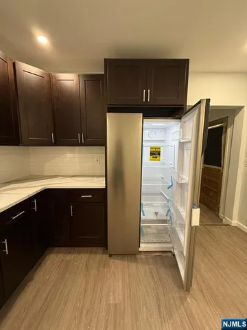 a kitchen with stainless steel appliances a refrigerator and a sink