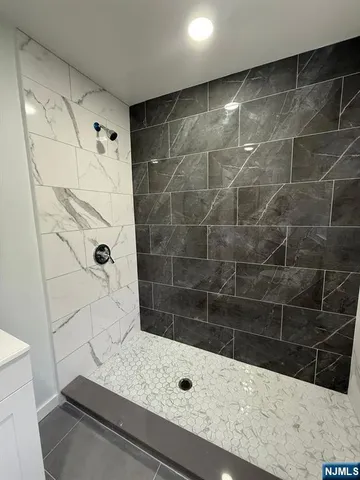 a bathroom with a bathtub and shower