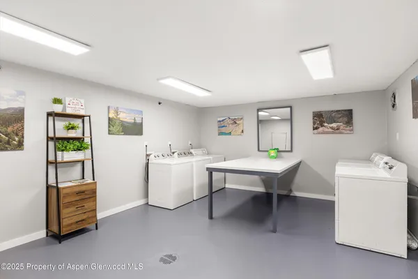 a room with furniture a rug and white walls