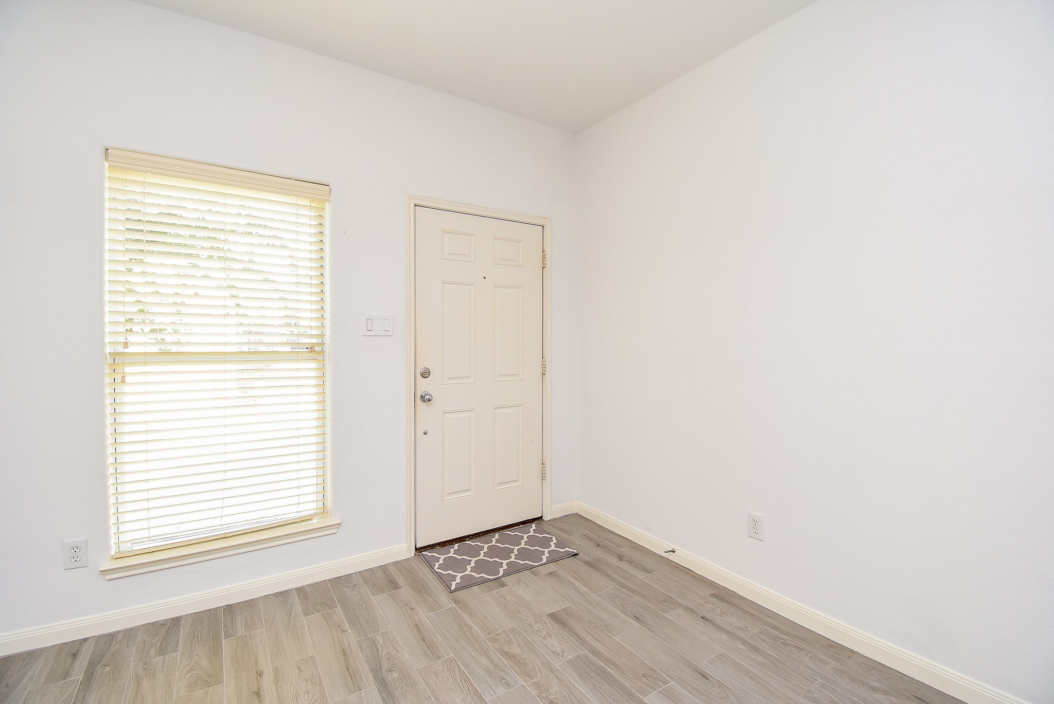 2202 Naomi Street, Unit 3 Houston, TX 77054 - Photo 4 of 42 a view of an empty room with wooden floor and a window