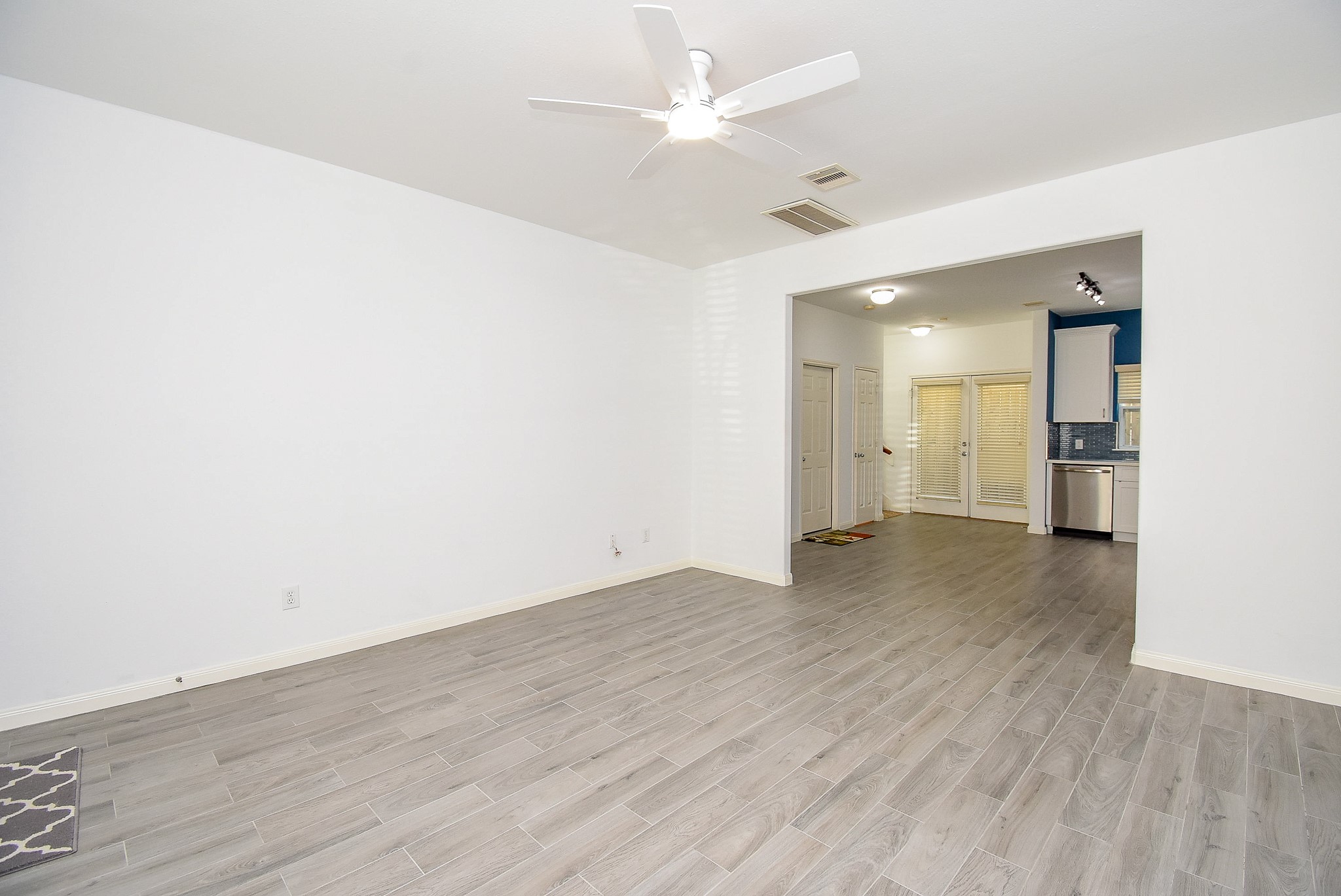 2202 Naomi Street, Unit 3 Houston, TX 77054 - Photo 6 of 42 an empty room with wooden floor and a ceiling fan