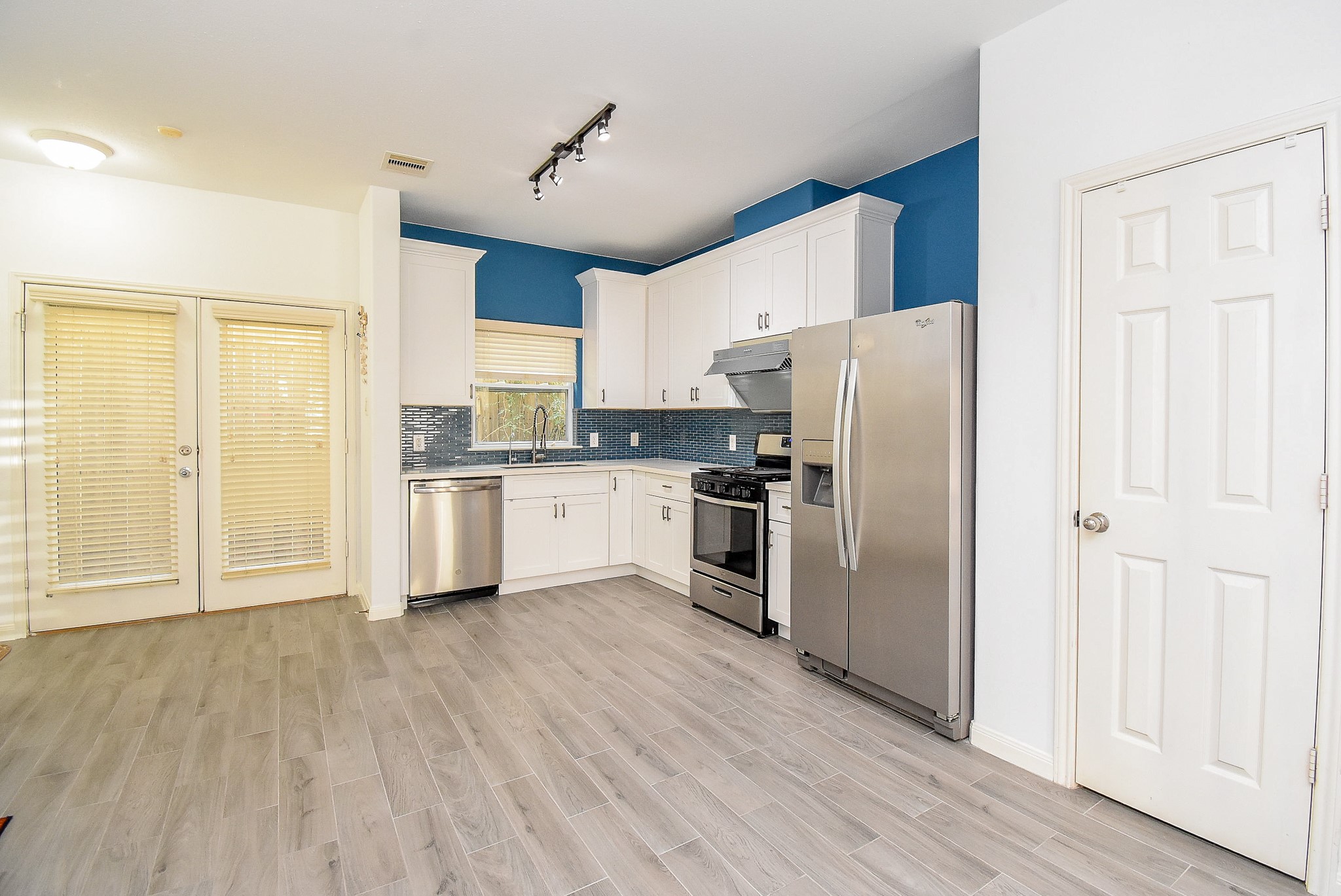 2202 Naomi Street, Unit 3 Houston, TX 77054 - Photo 9 of 42 a kitchen with stainless steel appliances a refrigerator and wooden floor