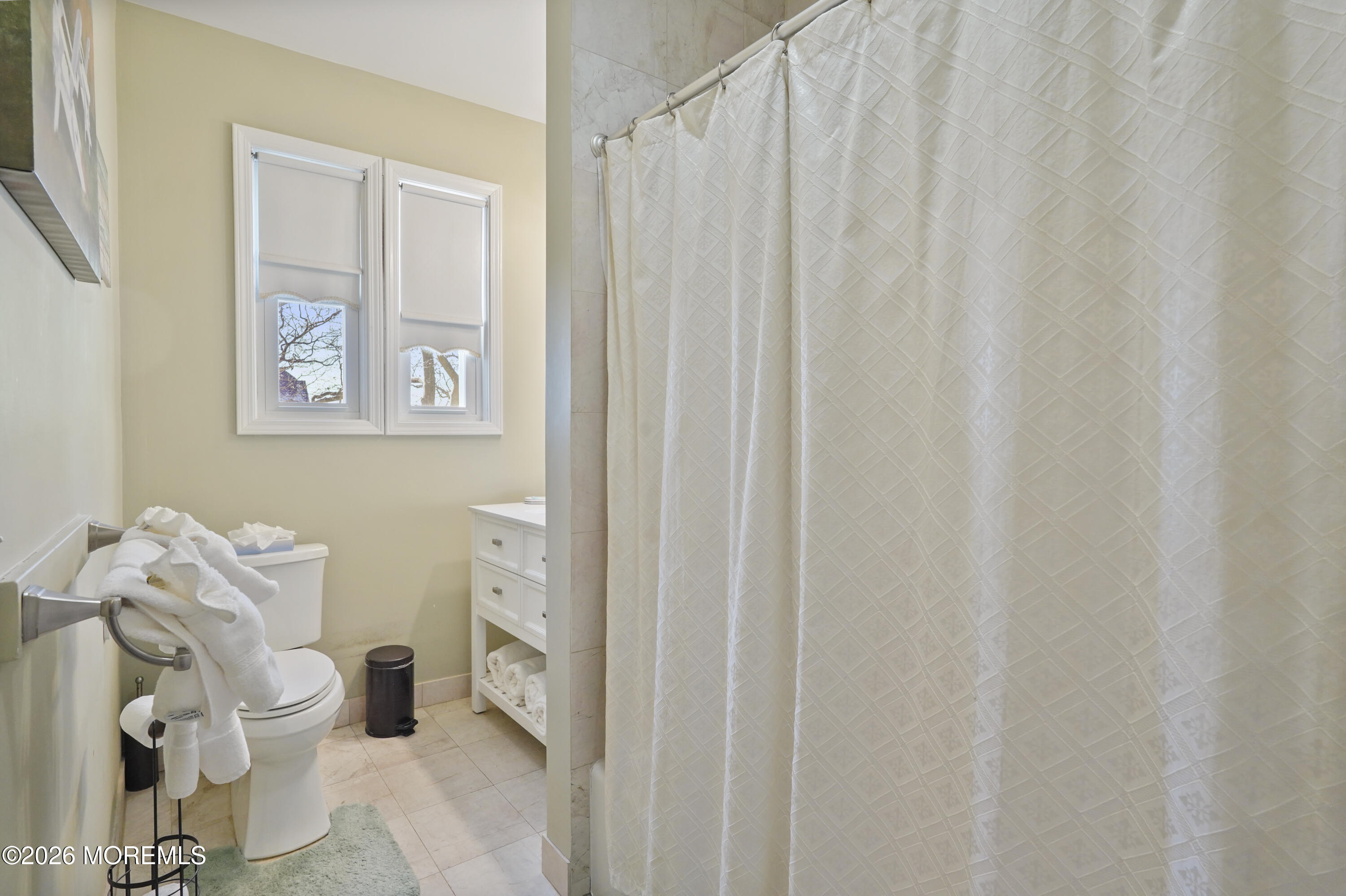200 Monmouth Avenue, Unit 21 Spring Lake, NJ 07762 - Photo 7 of 25 a bathroom with a toilet and a shower curtain