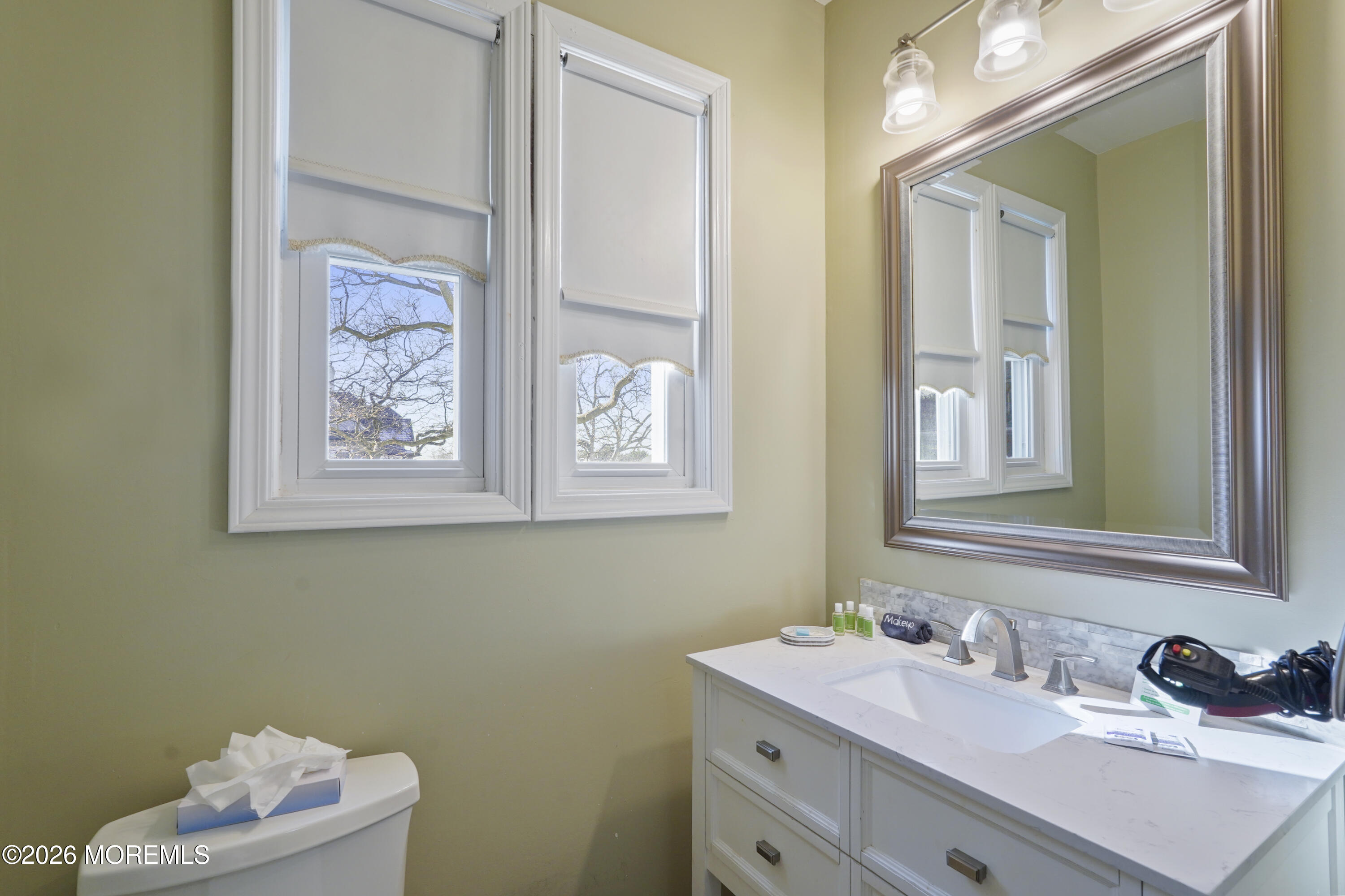 200 Monmouth Avenue, Unit 21 Spring Lake, NJ 07762 - Photo 8 of 25 a bathroom with a sink mirror and vanity