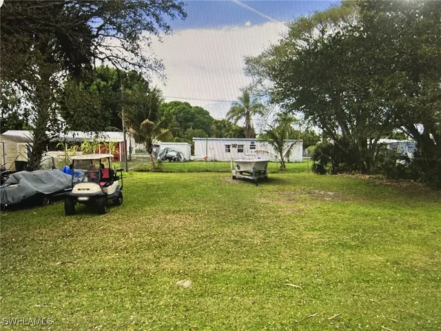 a view of yard with swimming pool and green space