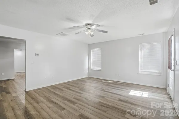 a view of a kitchen with wooden floor and a kitchen space