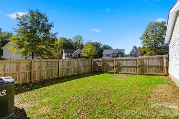 a backyard of a house with barbeque oven table and chairs