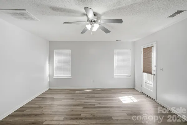 a dining room with furniture potted plants and wooden floor