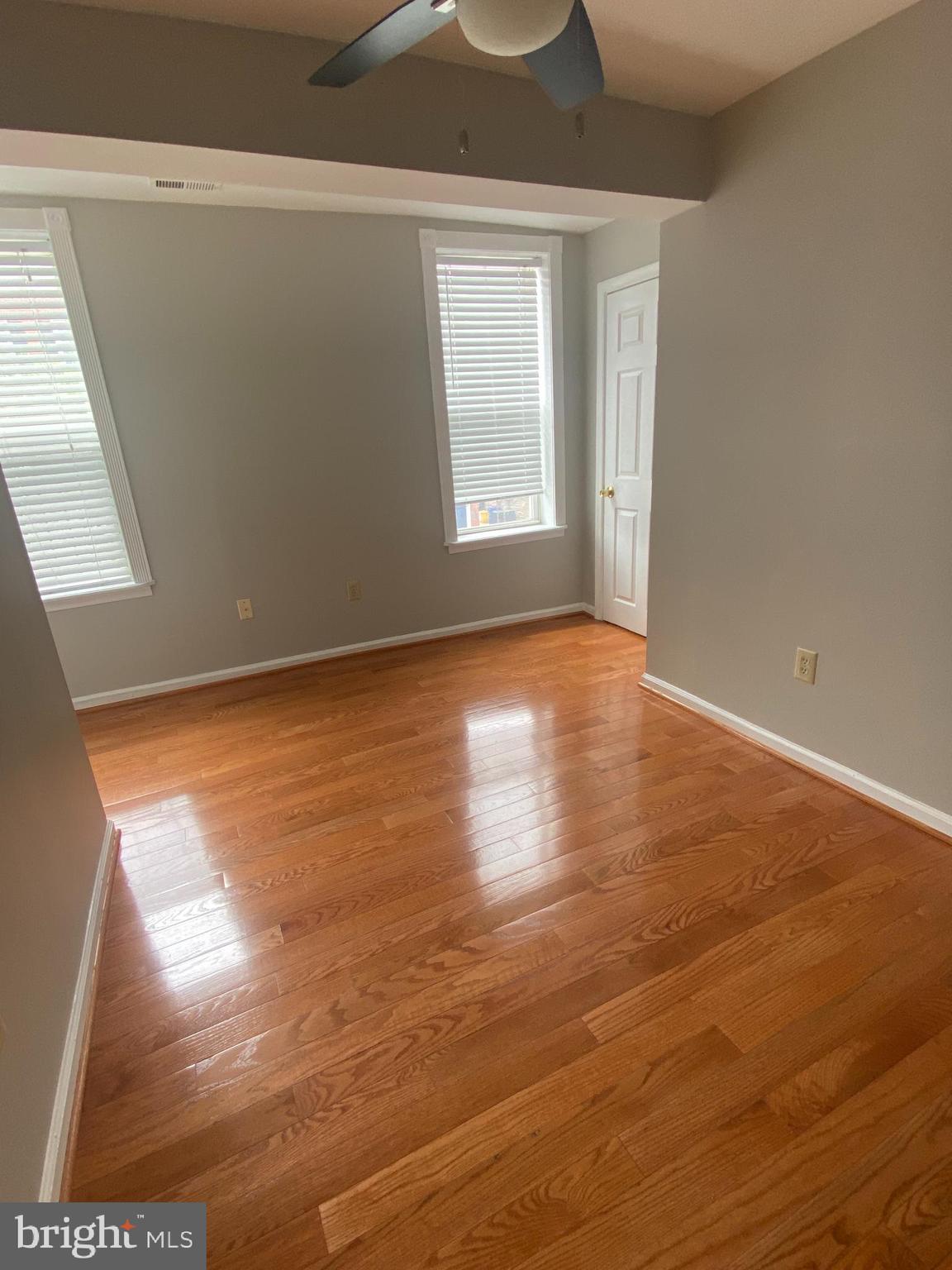 1458 Riverside Avenue, Unit 2C Baltimore, MD 21230 - Photo 13 of 14 an empty room with wooden floor and windows