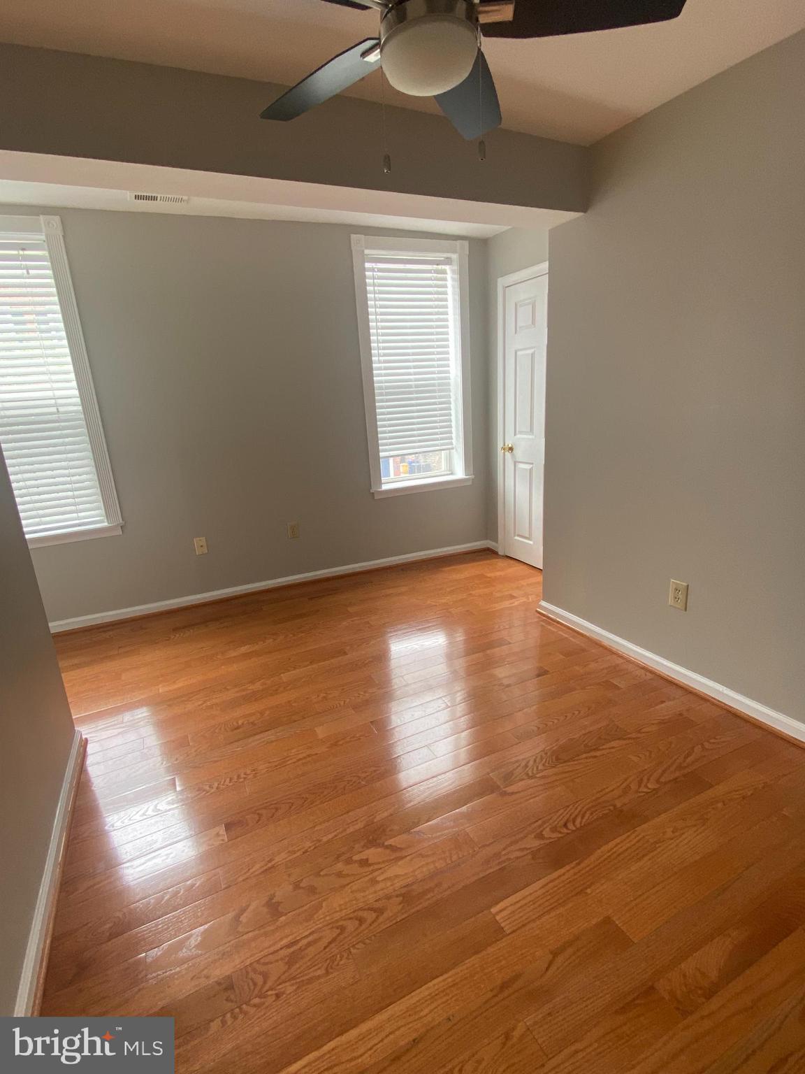 1458 Riverside Avenue, Unit 2C Baltimore, MD 21230 - Photo 14 of 14 a view of an empty room with wooden floor and a window