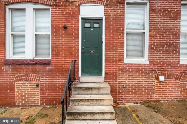 a view of a brick house with a large window