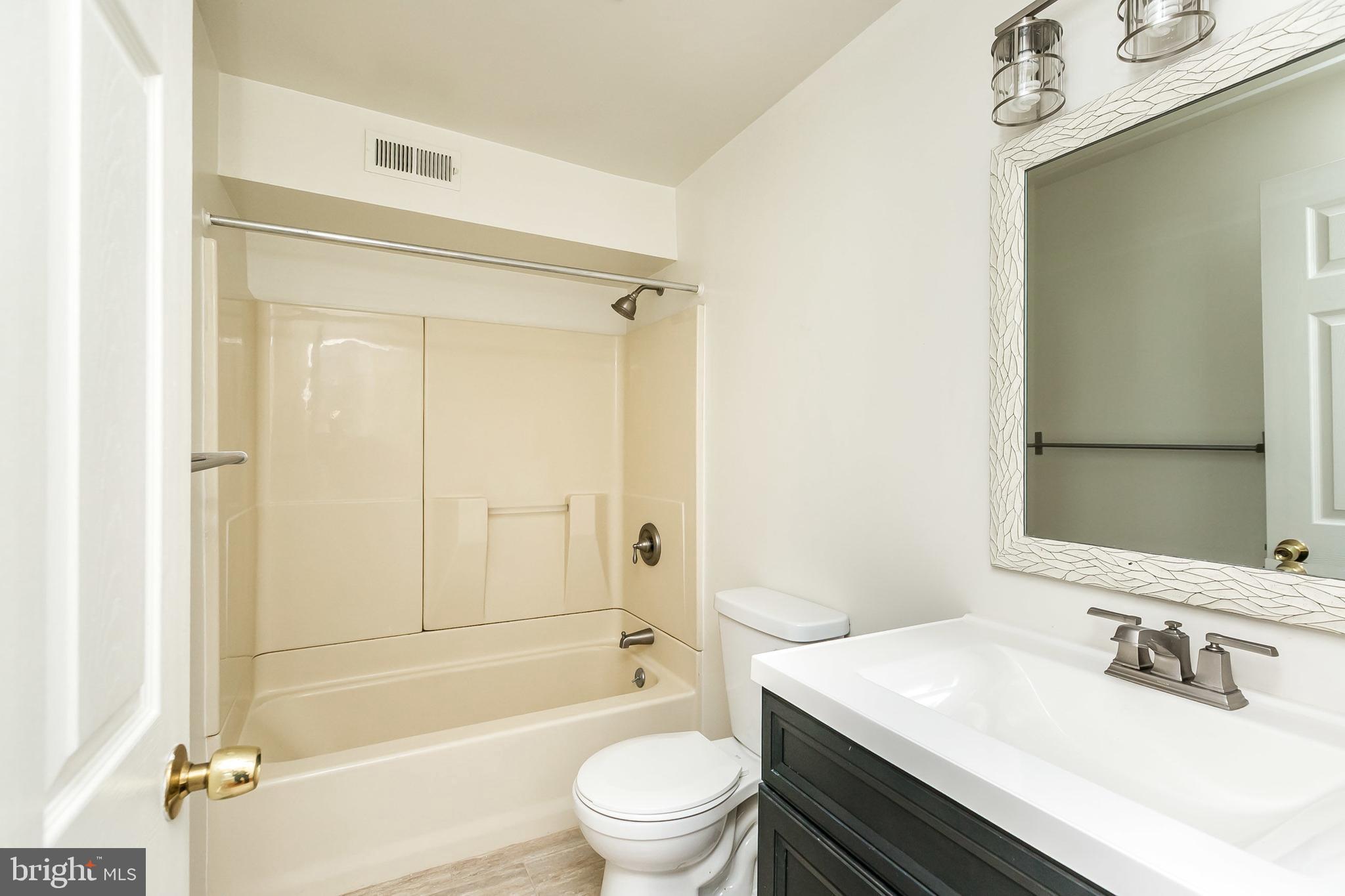 1458 Riverside Avenue, Unit 2C Baltimore, MD 21230 - Photo 6 of 14 a bathroom with a sink a toilet and shower