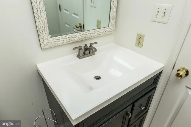 a view of a hallway with wooden floor and windows