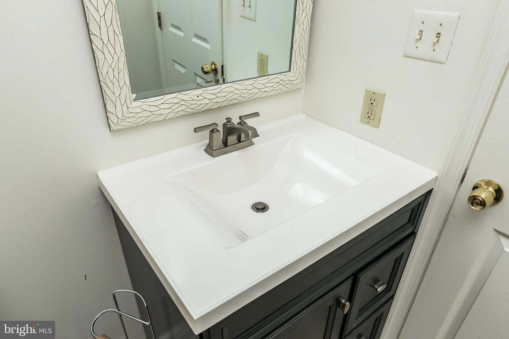 1458 Riverside Avenue, Unit 2C Baltimore, MD 21230 - Photo 8 of 14 a bathroom with a sink and a mirror