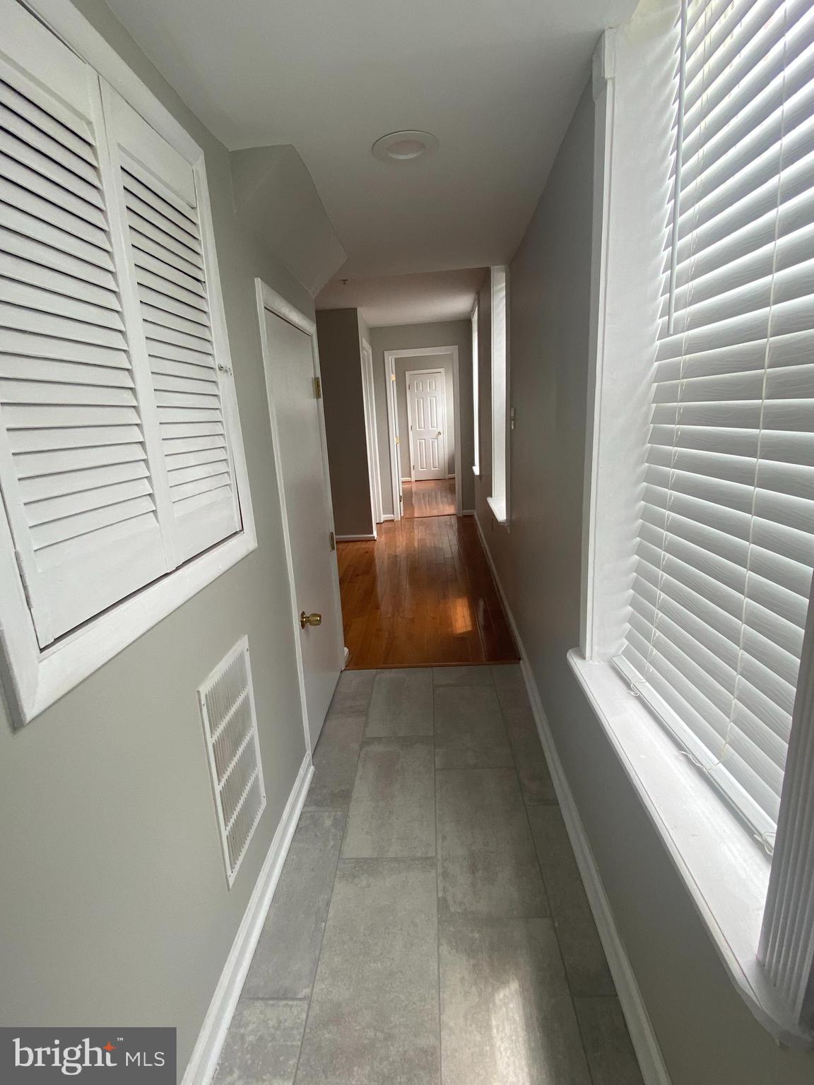 1458 Riverside Avenue, Unit 2C Baltimore, MD 21230 - Photo 9 of 14 a view of a hallway with wooden floor and windows