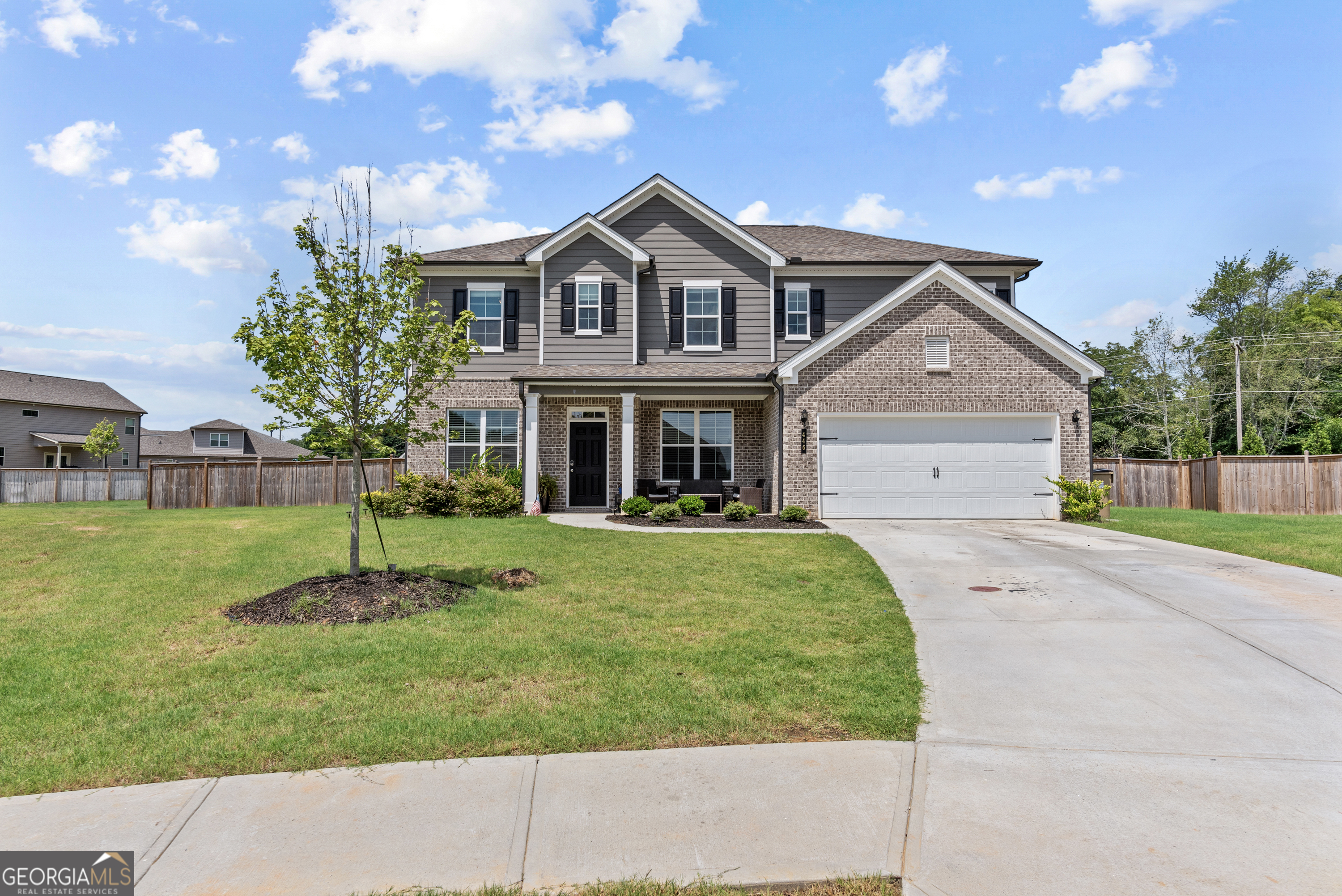 a front view of a house with a yard