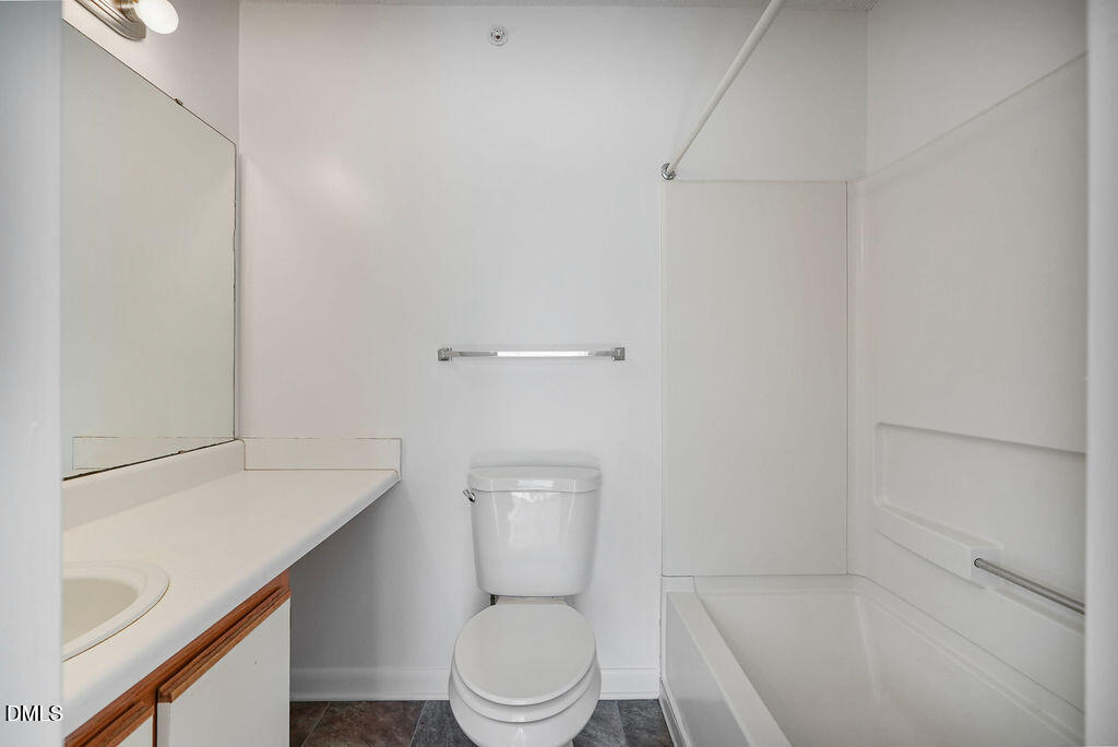 1411 Collegiate Circle, Unit 302 Raleigh, NC 27606 - Photo 23 of 43 a white toilet sitting next to a bathroom sink