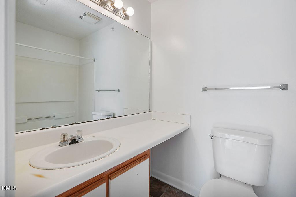 1411 Collegiate Circle, Unit 302 Raleigh, NC 27606 - Photo 24 of 43 a bathroom with a sink and a mirror