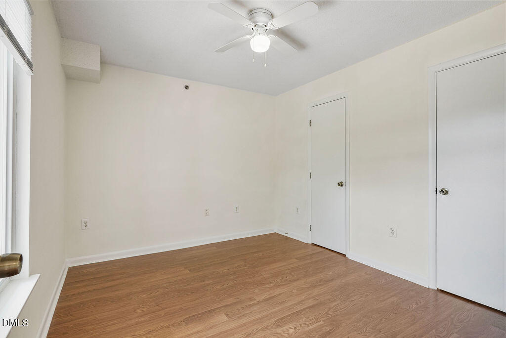 1411 Collegiate Circle, Unit 302 Raleigh, NC 27606 - Photo 31 of 43 a view of empty room with wooden floor