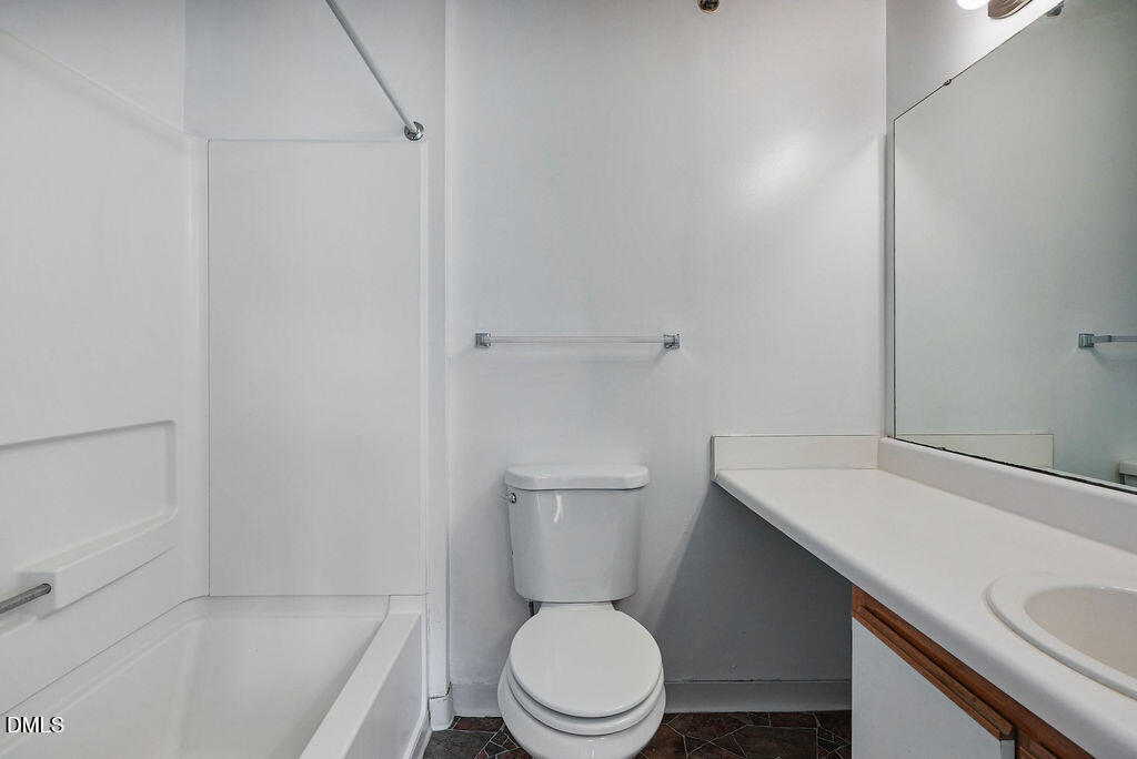 1411 Collegiate Circle, Unit 302 Raleigh, NC 27606 - Photo 33 of 43 a white toilet sitting next to a bath tub