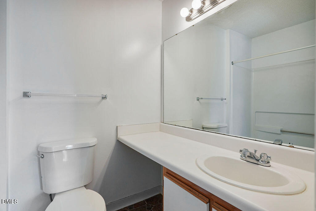 1411 Collegiate Circle, Unit 302 Raleigh, NC 27606 - Photo 34 of 43 a bathroom with a sink and a toilet